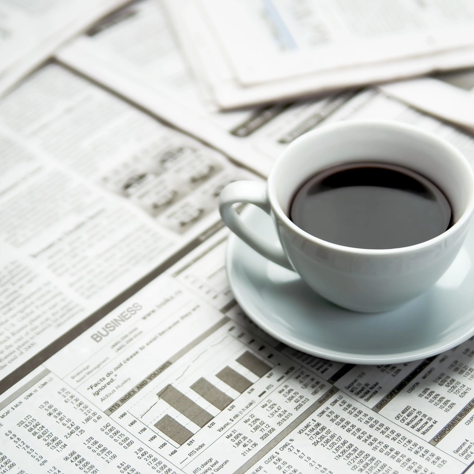 A cup of coffee on the newspaper from ICD Flooring in Hermitage